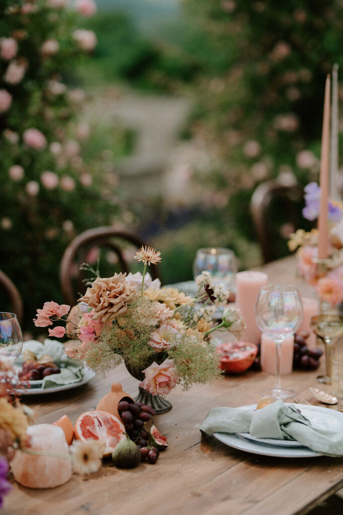 colourful outdoor wedding breakfast set up with spring florals and candlesticks at Euridge manor