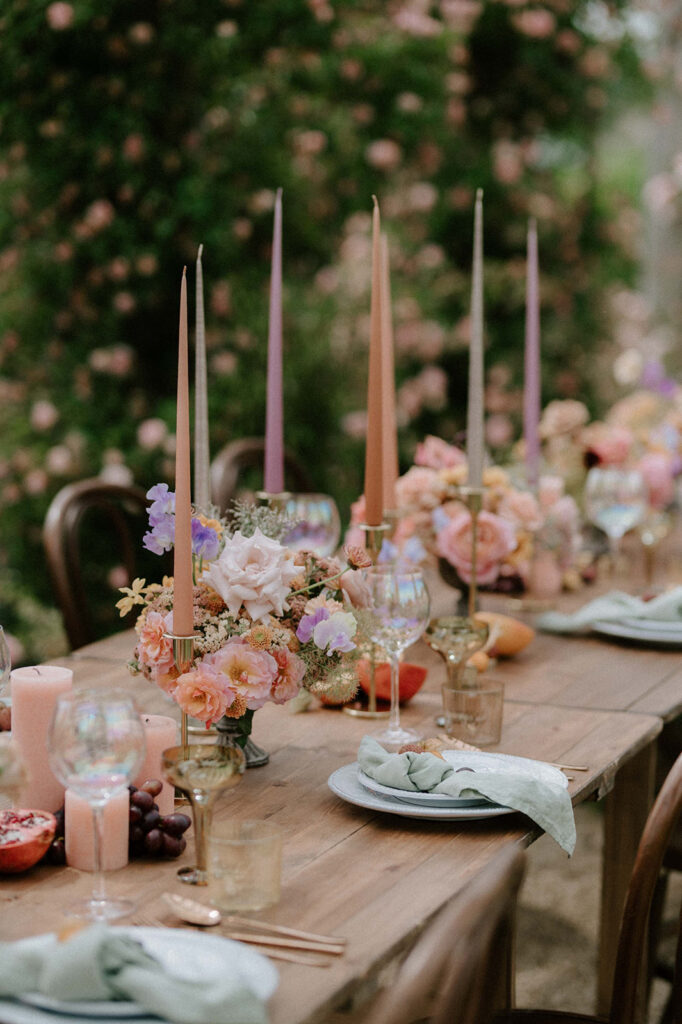 colourful outdoor wedding breakfast set up with spring florals and candlesticks at Euridge manor