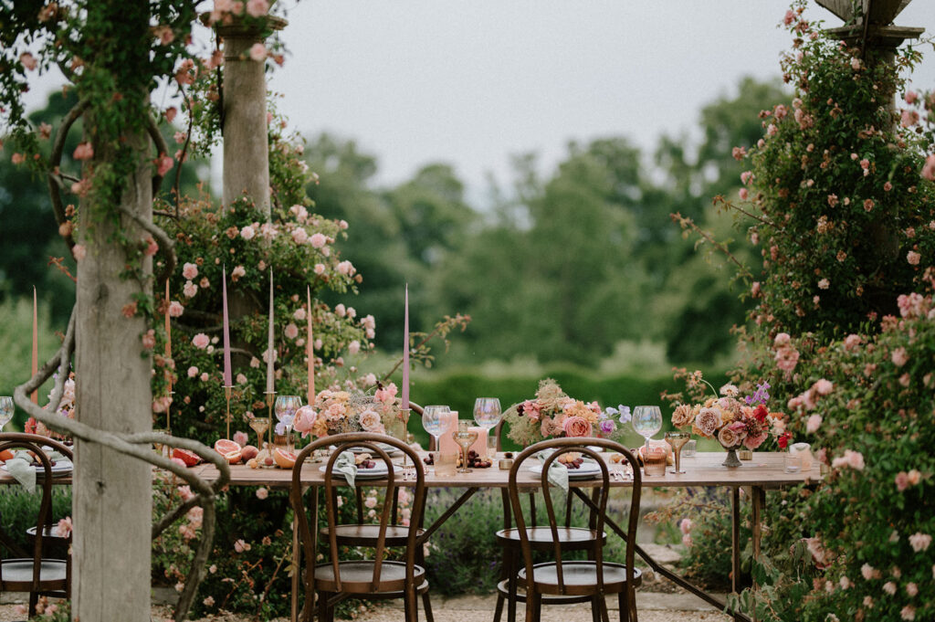 colourful outdoor wedding breakfast set up with spring florals and candlesticks at Euridge manor