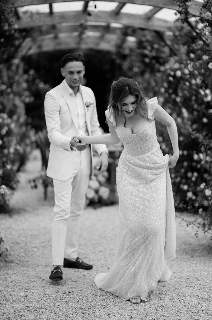 couple walking at euridge manor in rose garden
