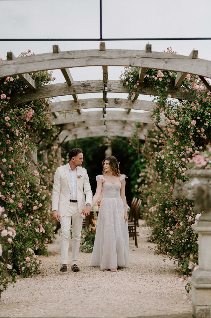 couple walking through rose garden at euridge manor