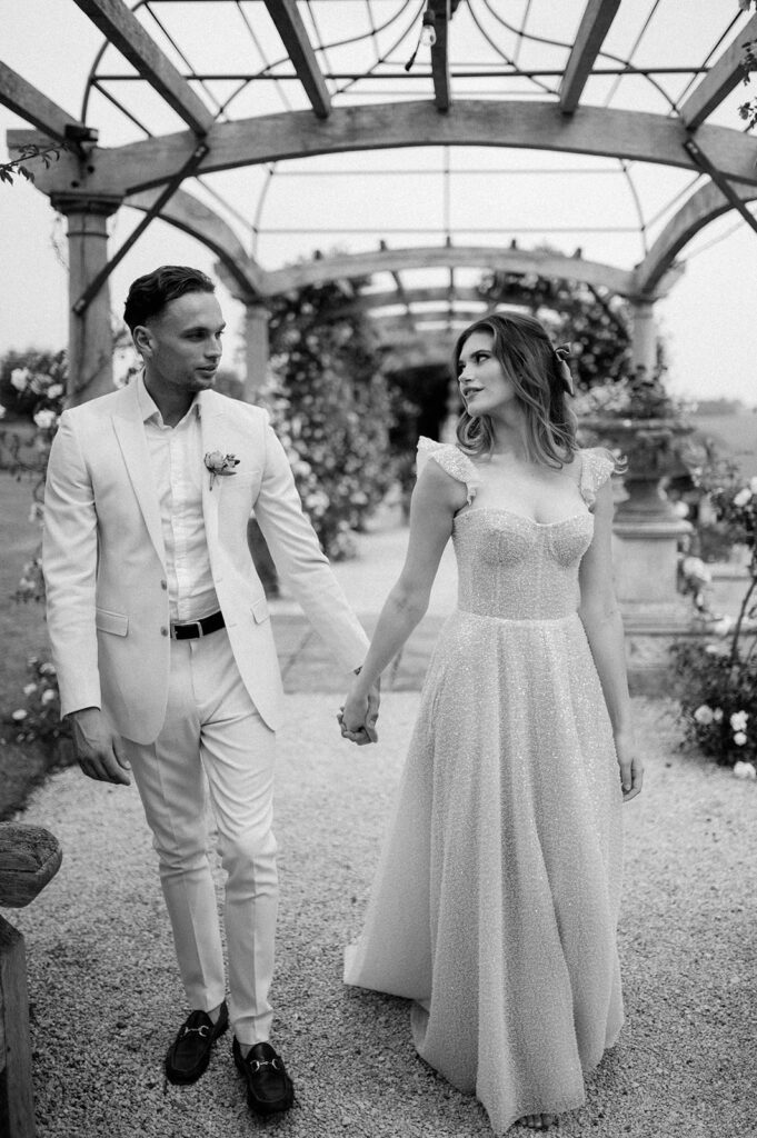 couple walking through rose garden at euridge manor