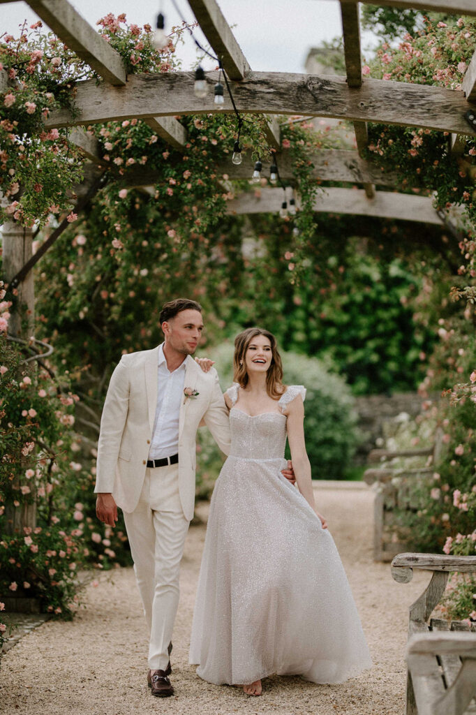 couple walking through rose garden at euridge manor