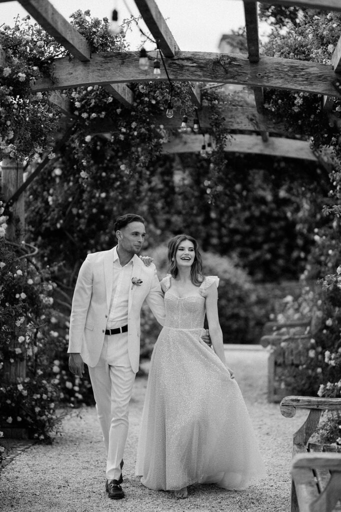 couple walking through rose garden at euridge manor