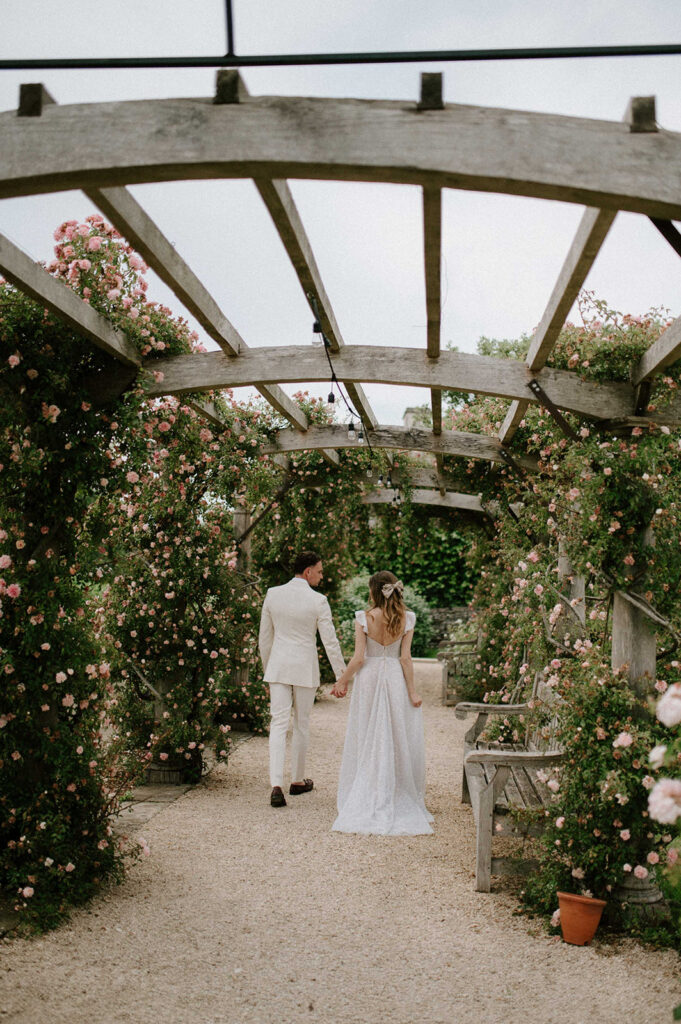 couple walking through rose garden at euridge manor
