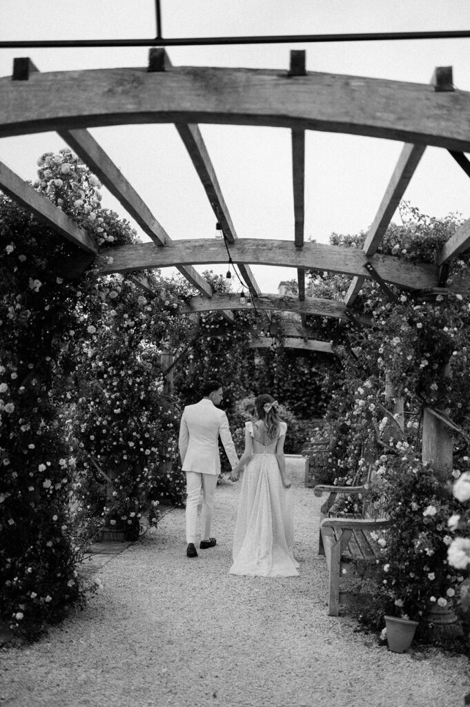 couple walking through rose garden at euridge manor