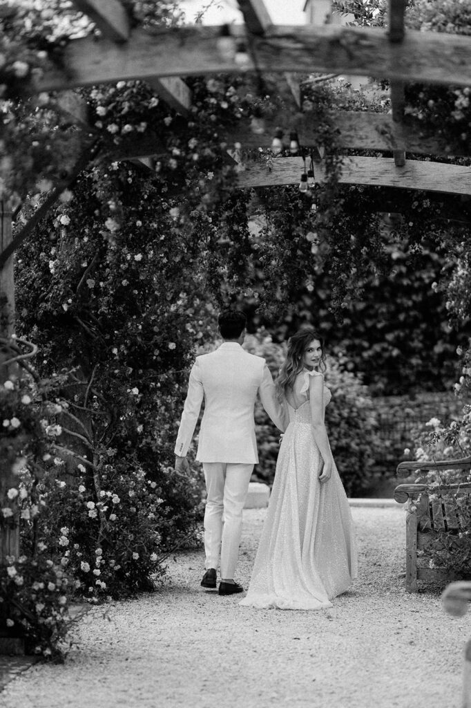 couple walking through rose garden at euridge manor