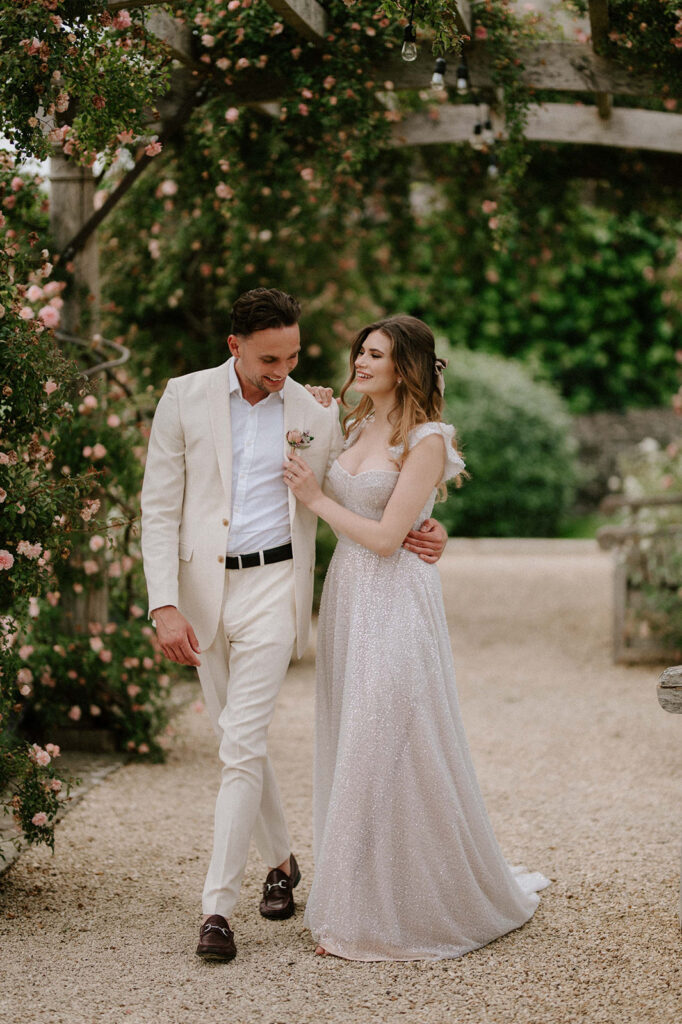 couple walking through rose garden at euridge manor