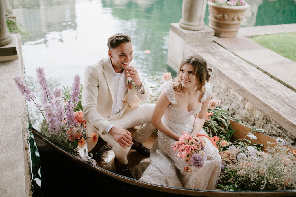 bride and groom in boat on lake at euridge manor