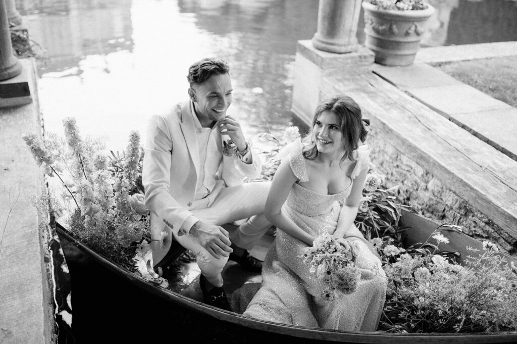 bride and groom in boat on lake at euridge manor