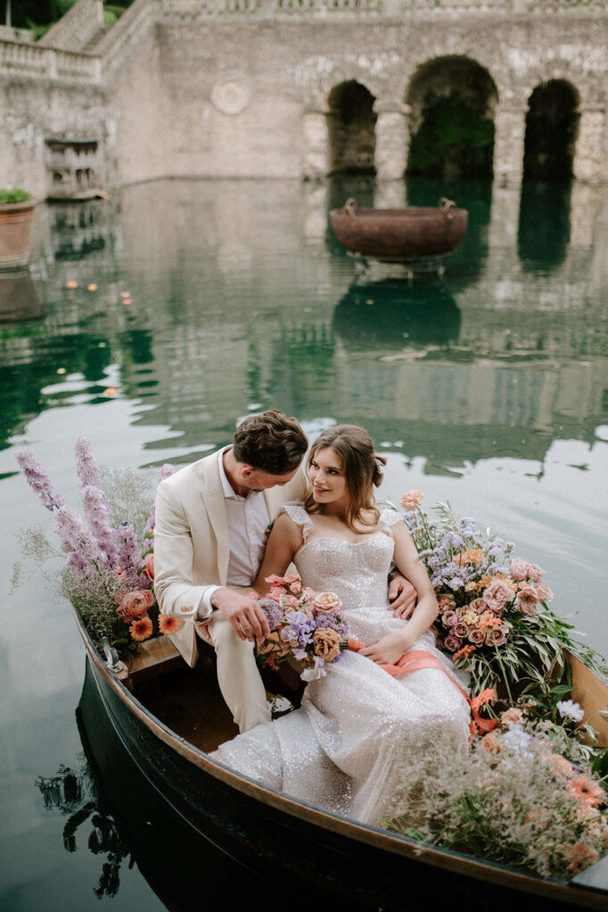 bride and groom in boat on lake at euridge manor