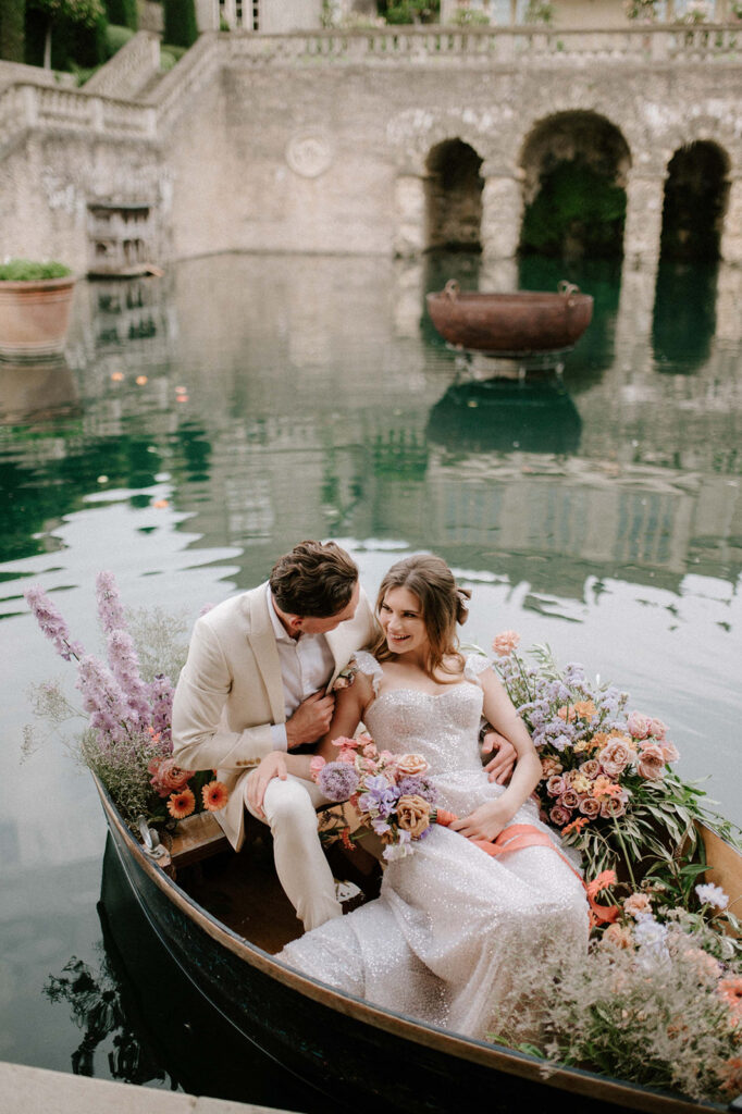 bride and groom in boat on lake at euridge manor