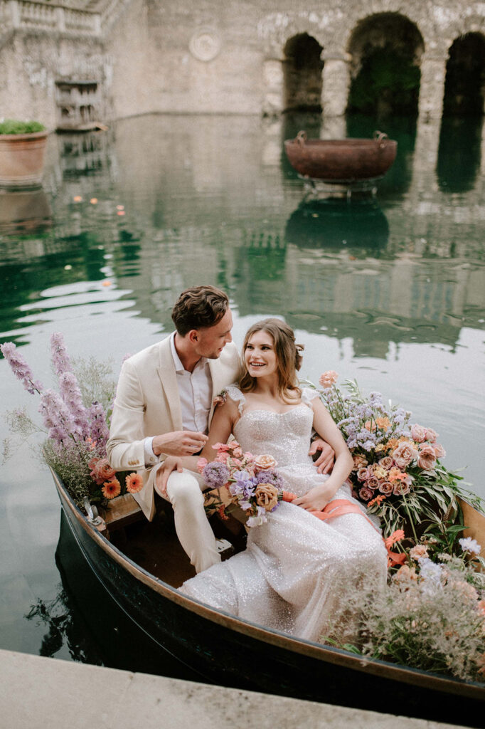 bride and groom in boat on lake at euridge manor