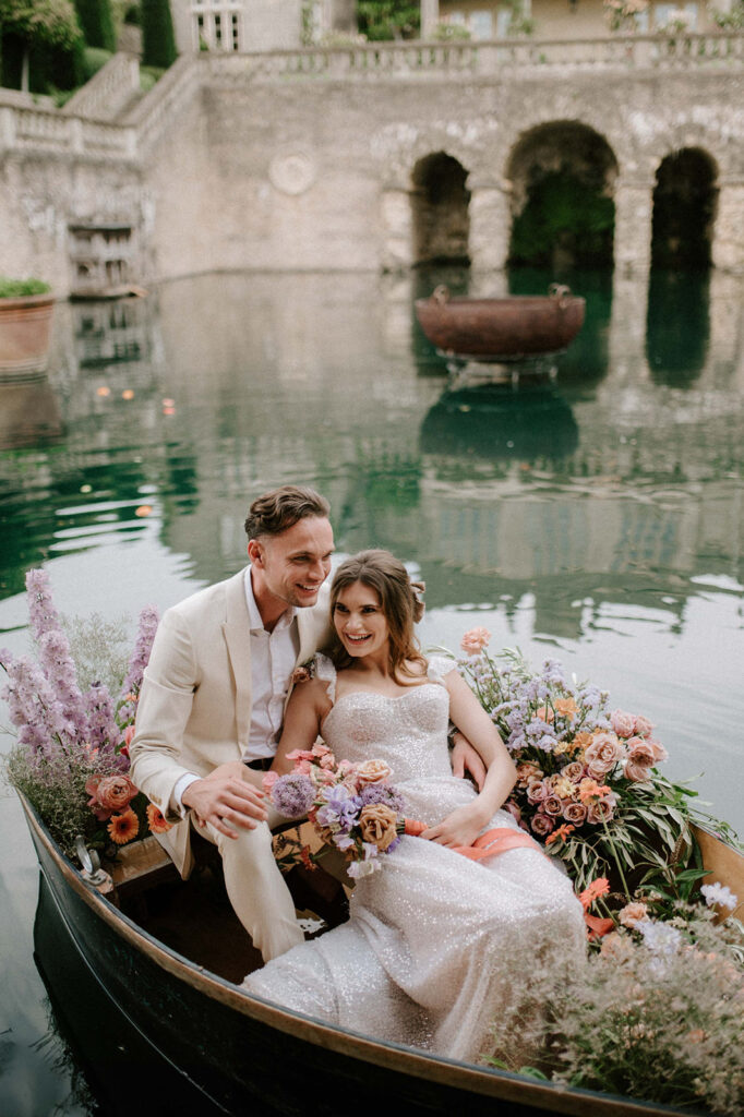 bride and groom in boat on lake at euridge manor