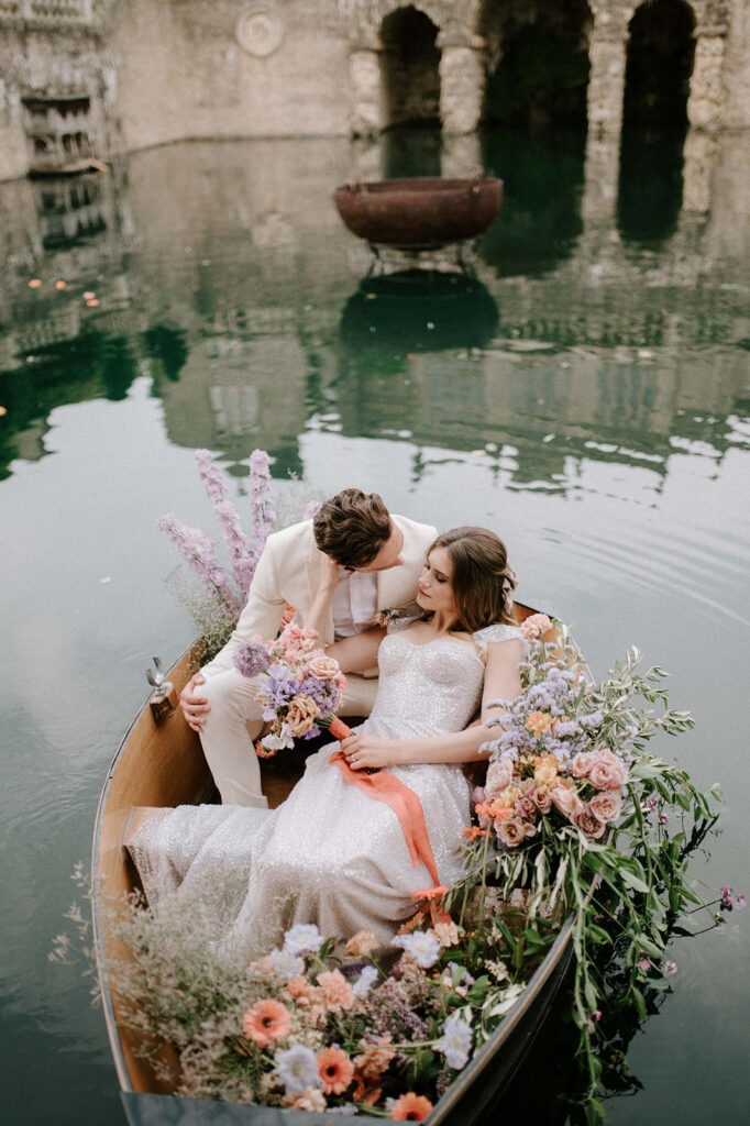 bride and groom in boat on lake at euridge manor