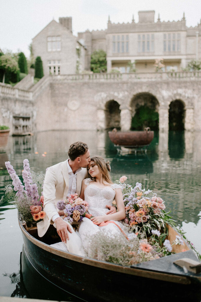bride and groom in boat on lake at euridge manor