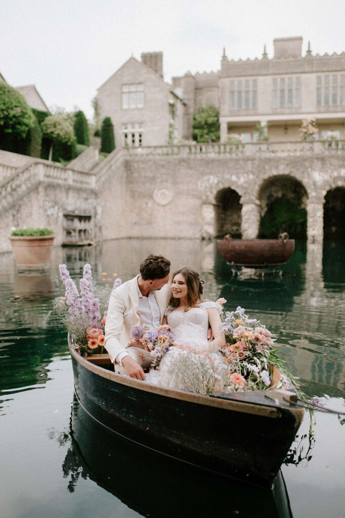 bride and groom in boat on lake at euridge manor