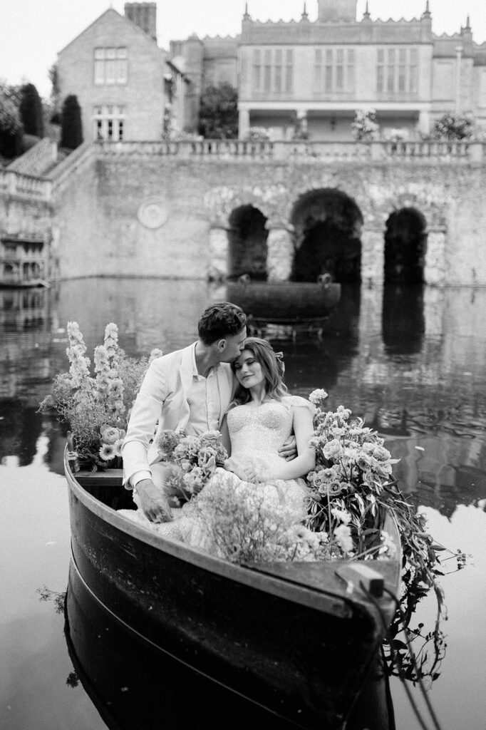 bride and groom in boat on lake at euridge manor