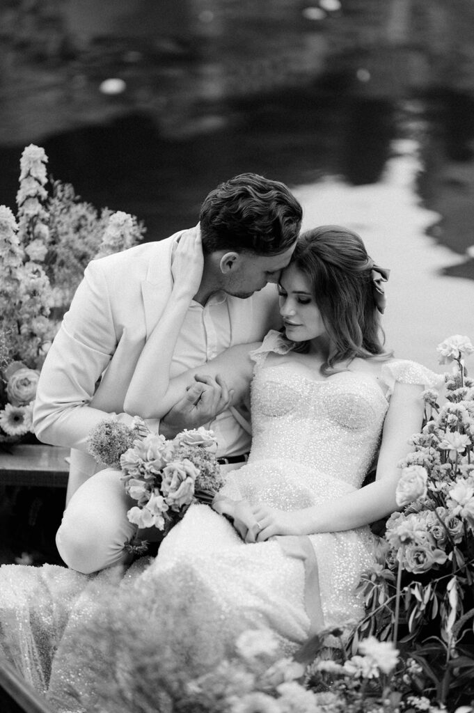 bride and groom in boat on lake at euridge manor