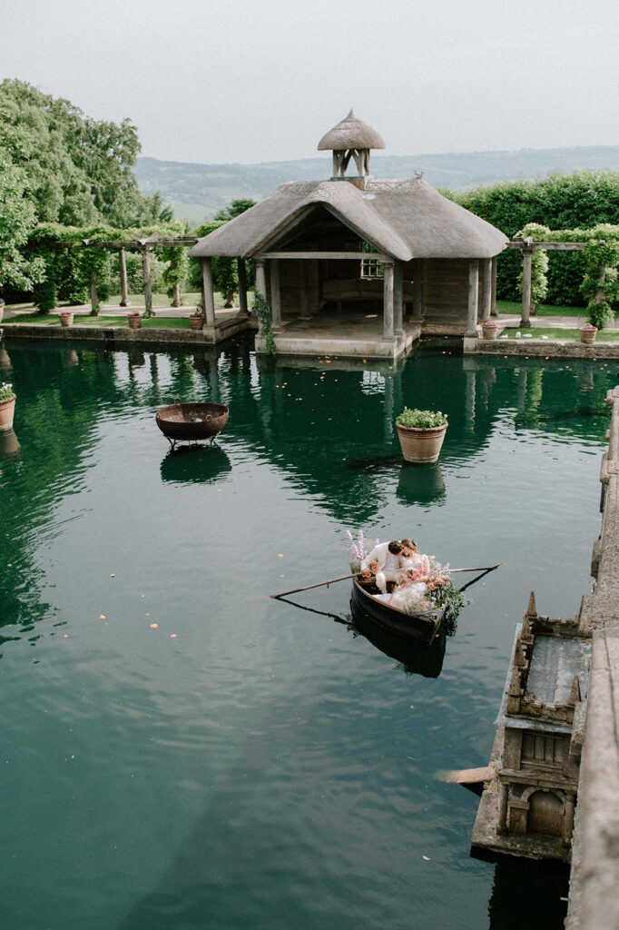 bride and groom in boat on lake at euridge manor