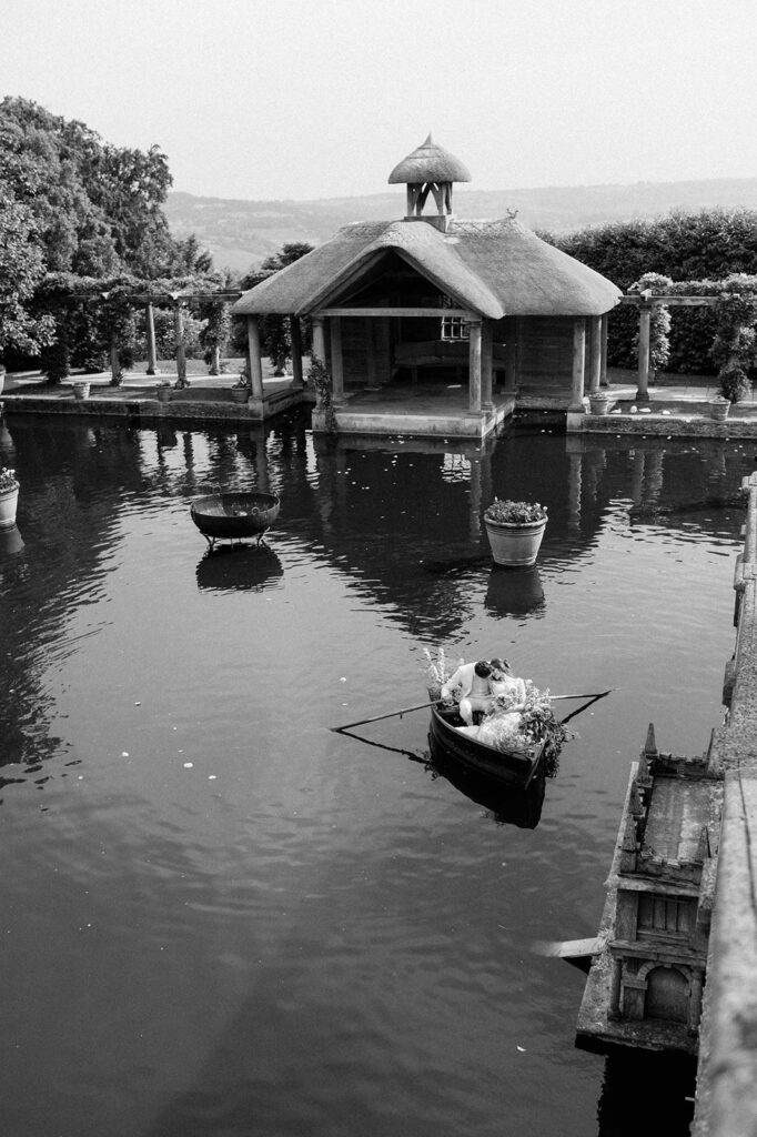 bride and groom in boat on lake at euridge manor