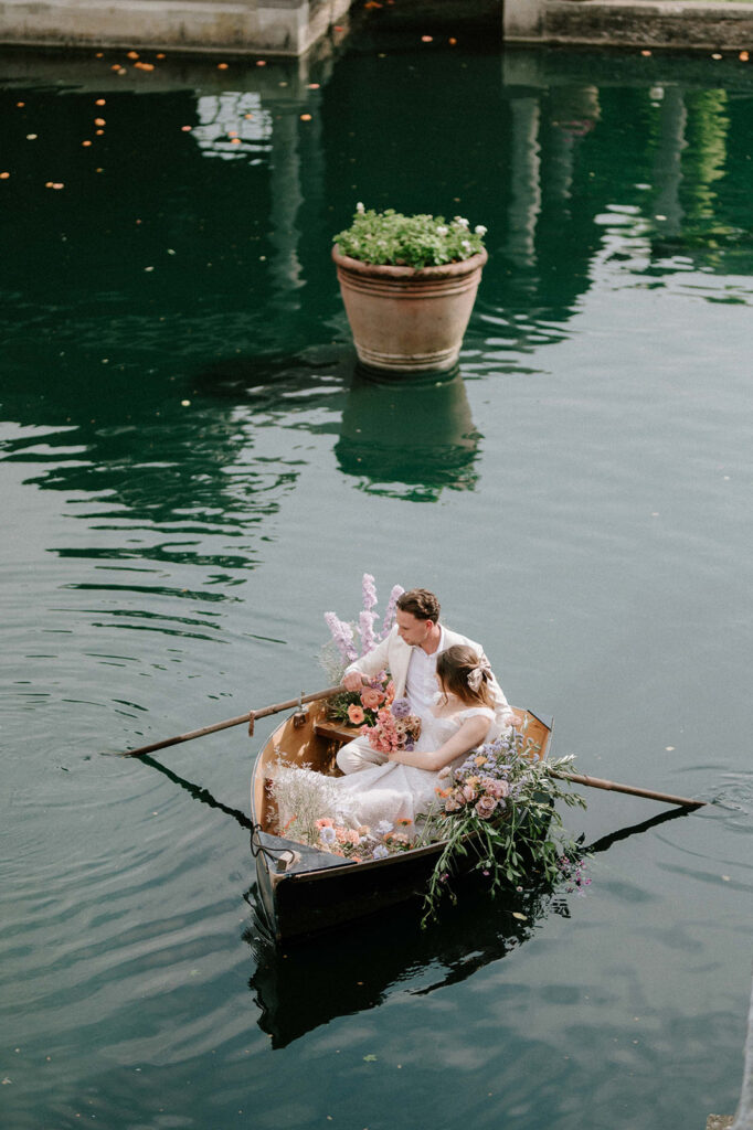 bride and groom in boat on lake at euridge manor