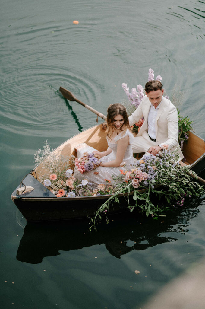 bride and groom in boat on lake at euridge manor