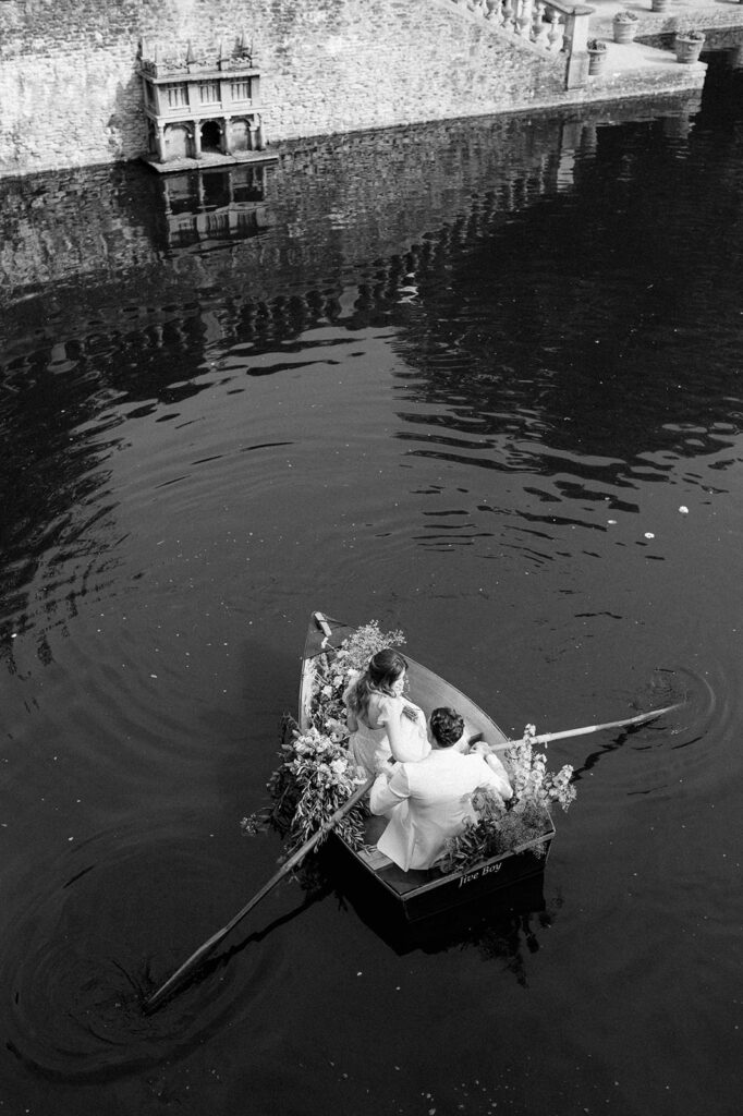 bride and groom in boat on lake at euridge manor