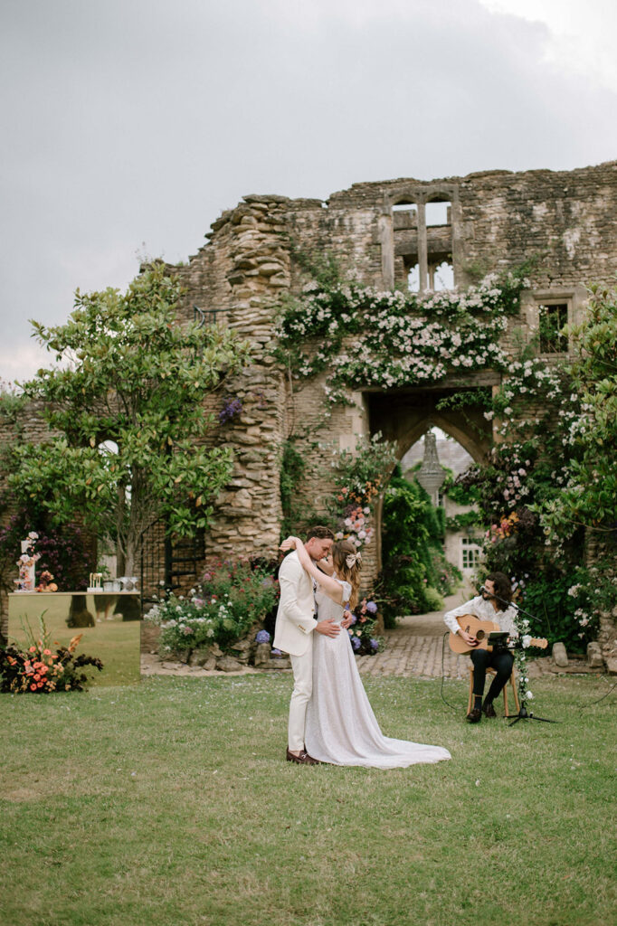 bride and groom having first dance outside in garden at euridge manor