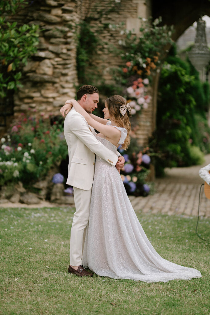 bride and groom having first dance outside in garden at euridge manor