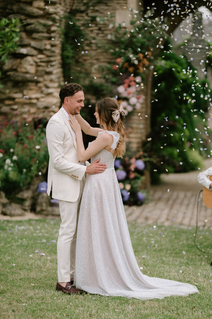 bride and groom having first dance outside in garden at euridge manor