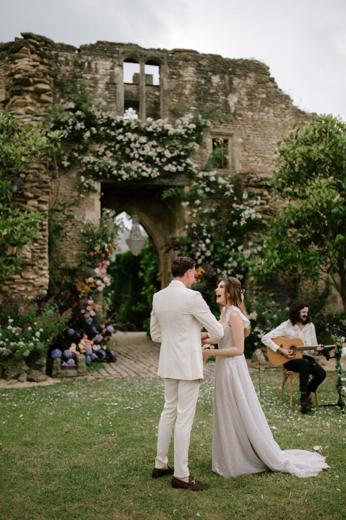 bride and groom having first dance outside in garden at euridge manor