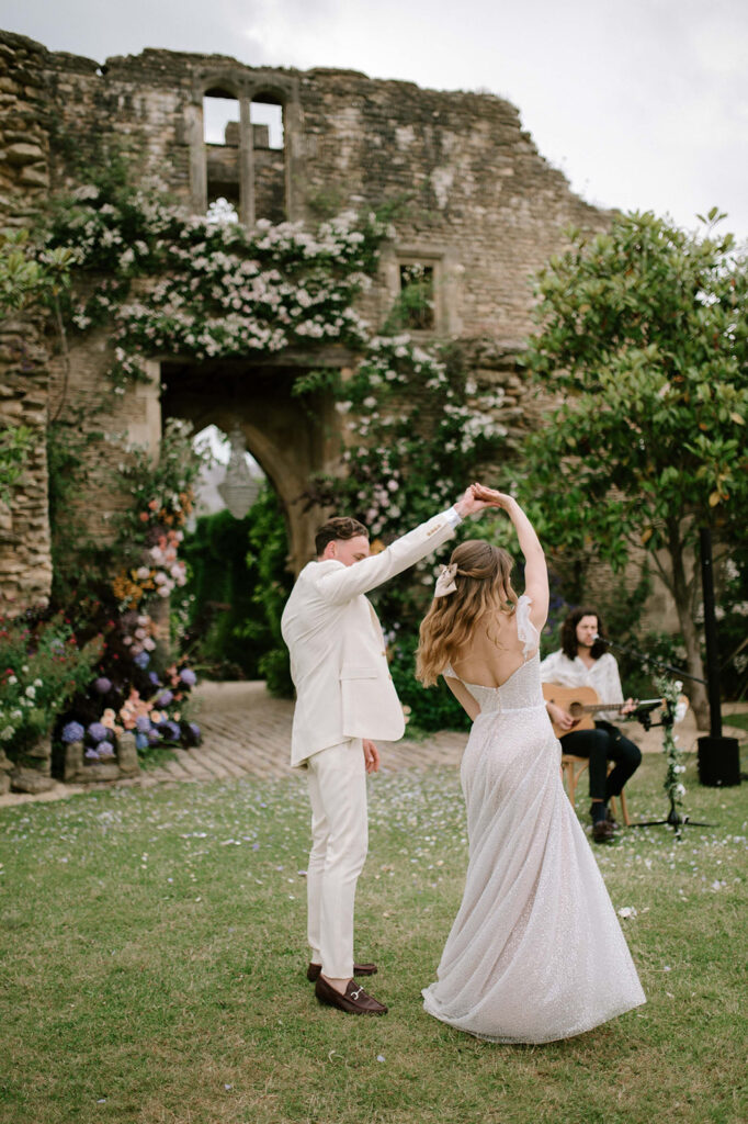 bride and groom having first dance outside in garden at euridge manor