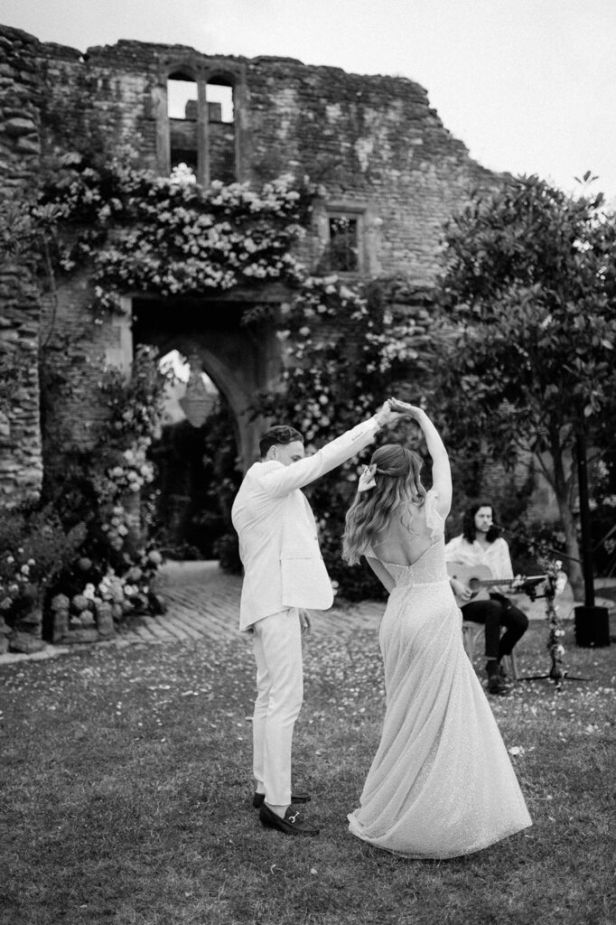 bride and groom having first dance outside in garden at euridge manor