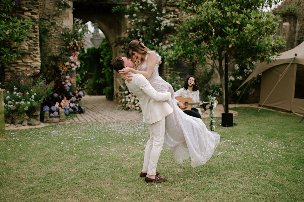 bride and groom having first dance outside in garden at euridge manor