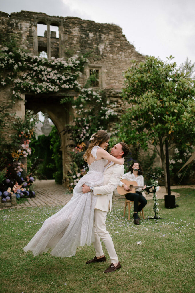 bride and groom having first dance outside in garden at euridge manor