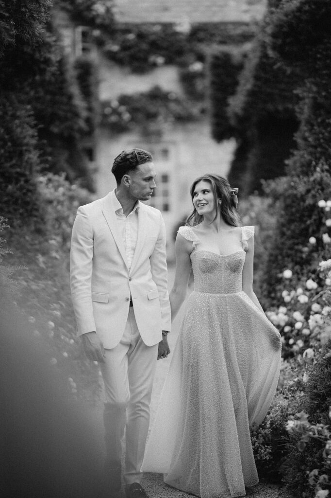 bride and groom walking through gardens at euridge manor