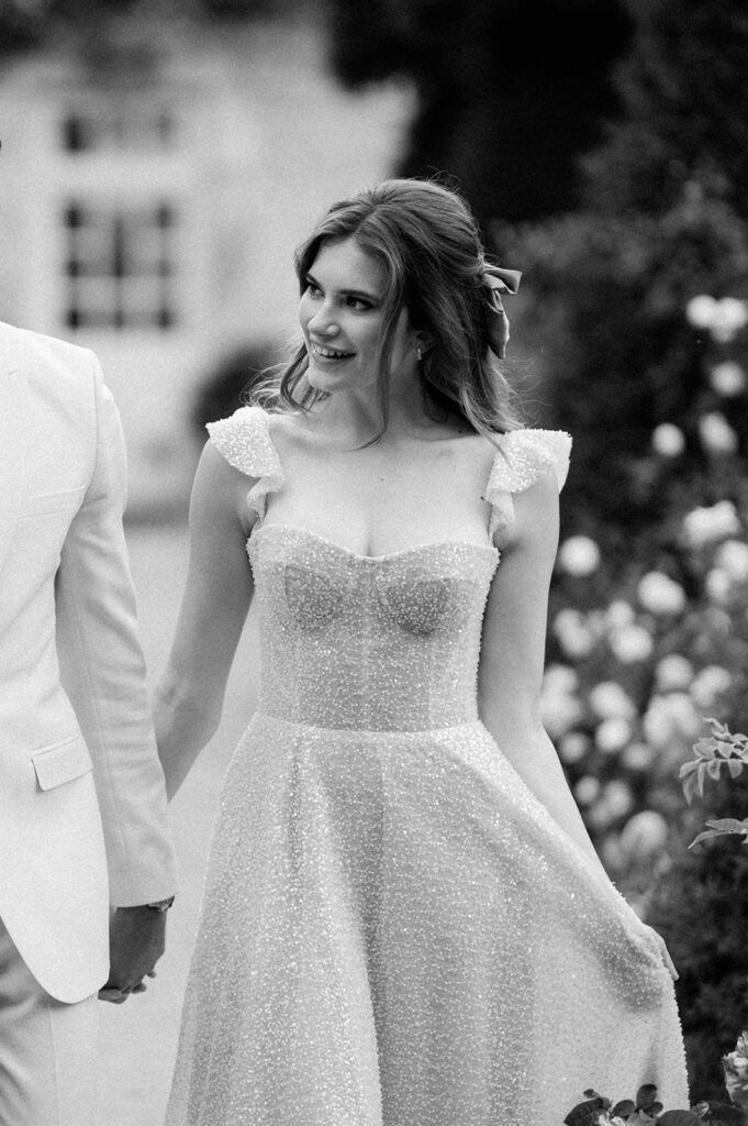 bride and groom walking through gardens at euridge manor