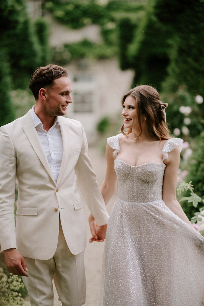 bride and groom walking through gardens at euridge manor