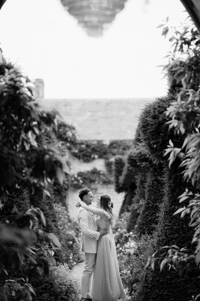 bride and groom walking through gardens at euridge manor