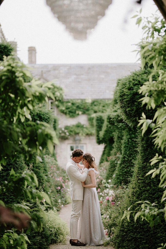 bride and groom walking through gardens at euridge manor