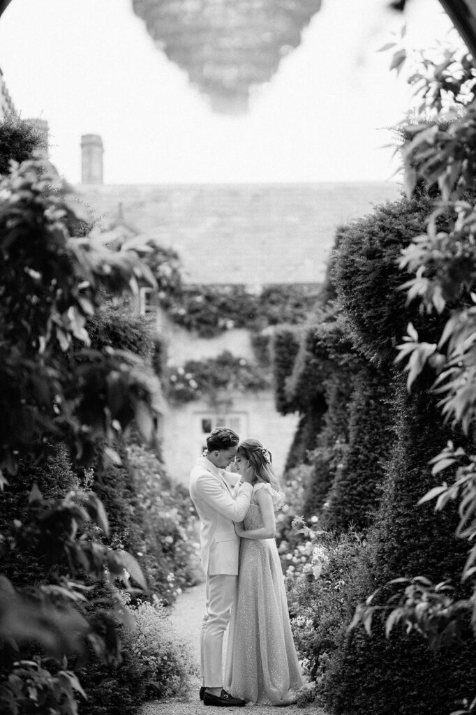bride and groom walking through gardens at euridge manor