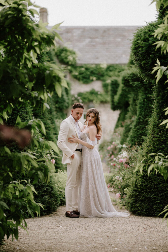 bride and groom walking through gardens at euridge manor