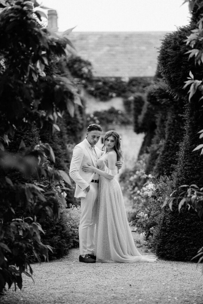 bride and groom walking through gardens at euridge manor