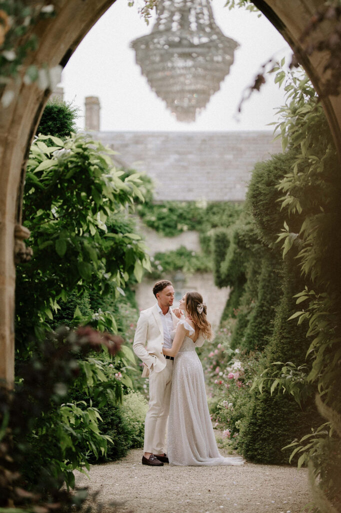 bride and groom walking through gardens at euridge manor