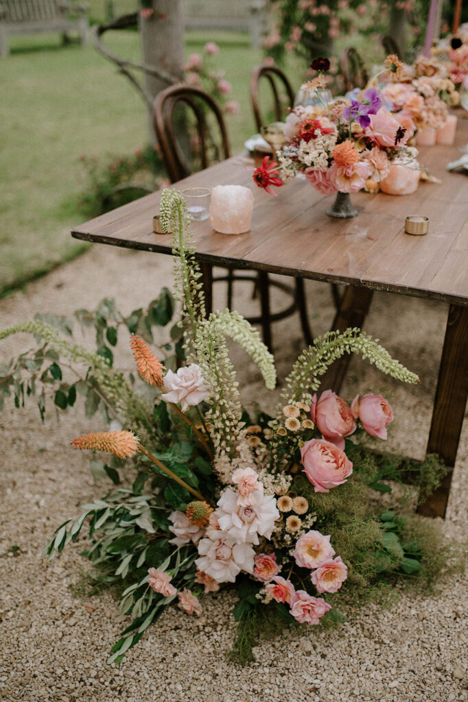 colourful outdoor wedding breakfast set up in gardens of Euridge Manor
