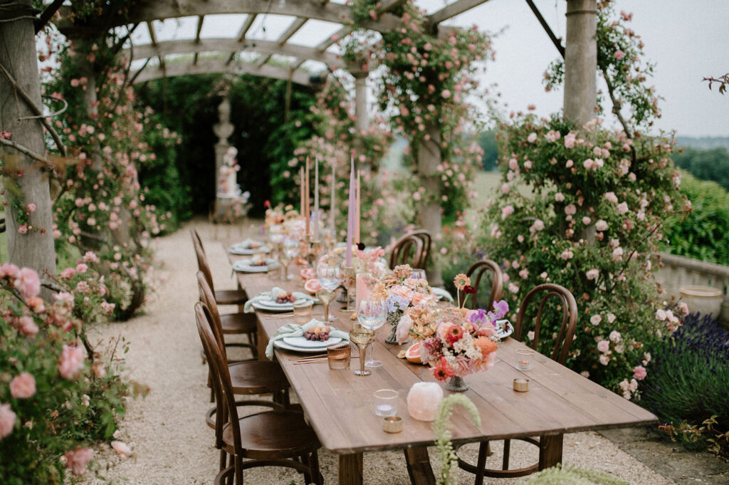 colourful outdoor wedding breakfast set up in gardens of Euridge Manor