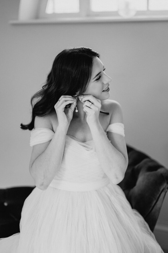 bride putting on earrings