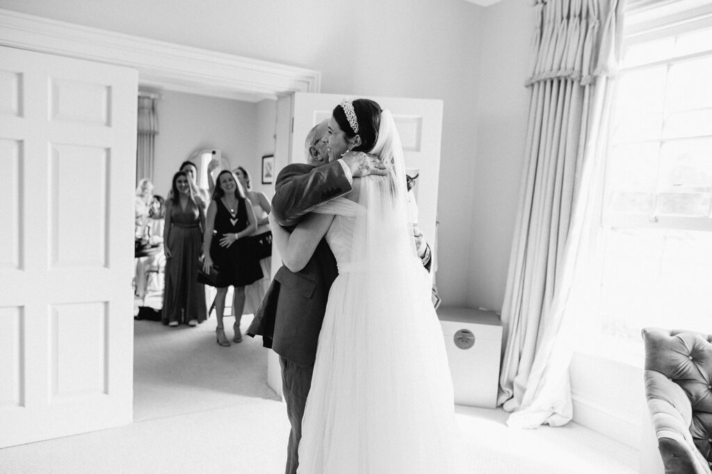 father hugging bride