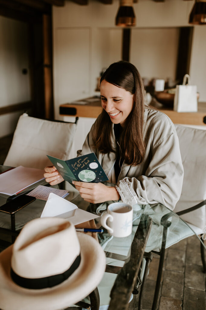 bride reading card on wedding morning